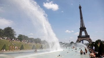 People cool off in the Trocadero fountains across from the Eiffel Tower in Paris as a heatwave hit much of the country