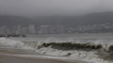 A view of a beach as waves move toward the shore during rainfall brought on by Hurricane Raymond, in Acapulco