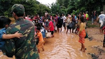 Villagers carry their belonging as they evacuate after the Xepian-Xe Nam Noy hydropower dam collapsed in Attapeu province