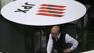 An employee of the TSE works at the bourse in Tokyo