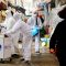 A woman wearing a mask to prevent contracting the coronavirus reacts as employees from a disinfection service company sanitize a traditional market in Seoul