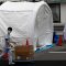 Medical workers walk by tents set up to test for the coronavirus disease (COVID-19) infection at Kawakita General Hospital in Tokyo